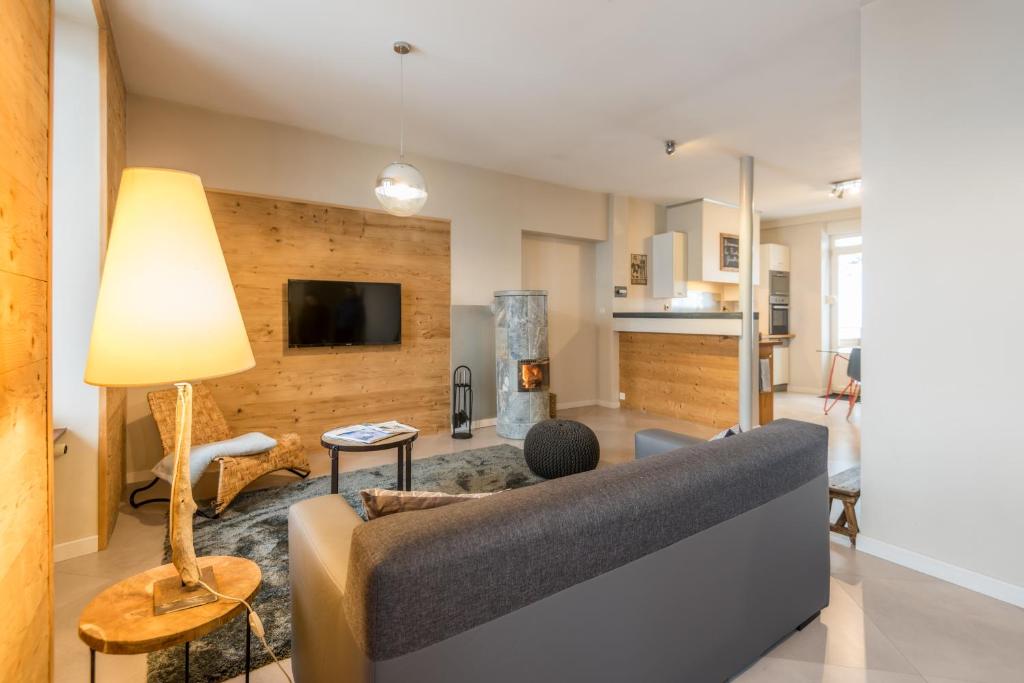 a living room with a couch and a tv at la roche gauthier 4 personnes in Gérardmer