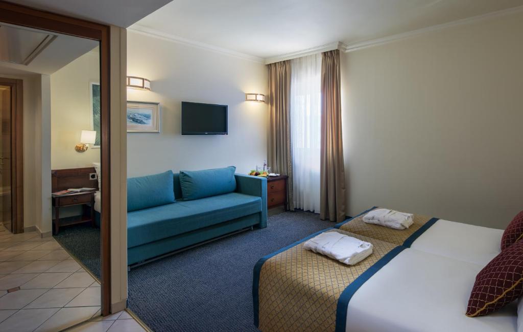 Postel nebo postele na pokoji v ubytování Prima Palace Hotel