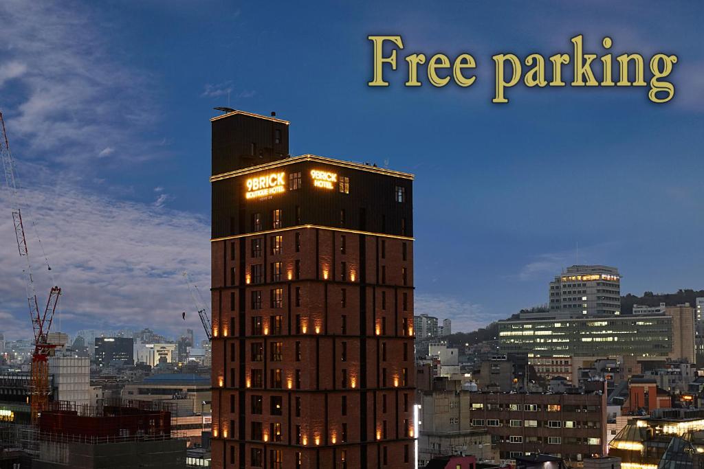 a tall building with lights on top of it at 9 Brick Hotel in Seoul