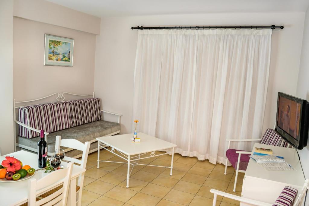 a living room with a couch and a table at Aktea Beach Village in Ayia Napa