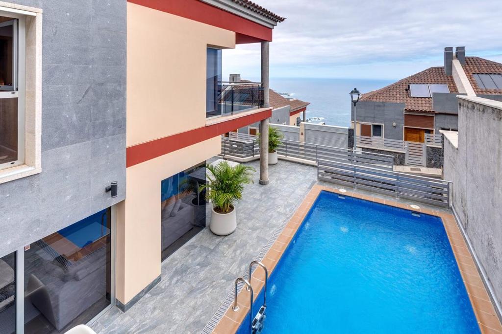 - une vue sur la piscine depuis le balcon d'une maison dans l'établissement SuperMakar10 - Green Palm, à Santa Úrsula