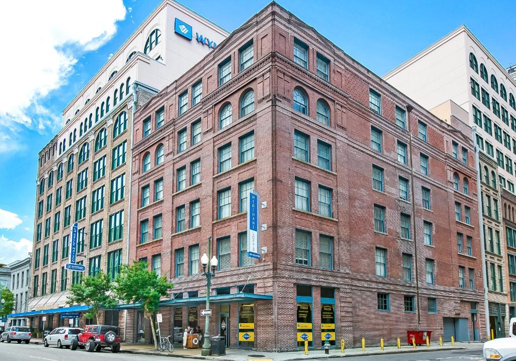 a large red brick building on a city street at Stunning Apartments - Near FQ and Bourbon in New Orleans