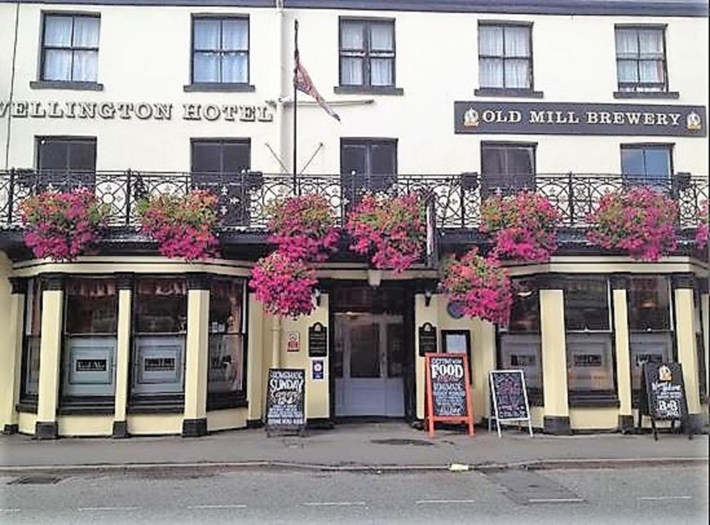 a building with flowers on the front of it at The Wellington Hotel in Howden