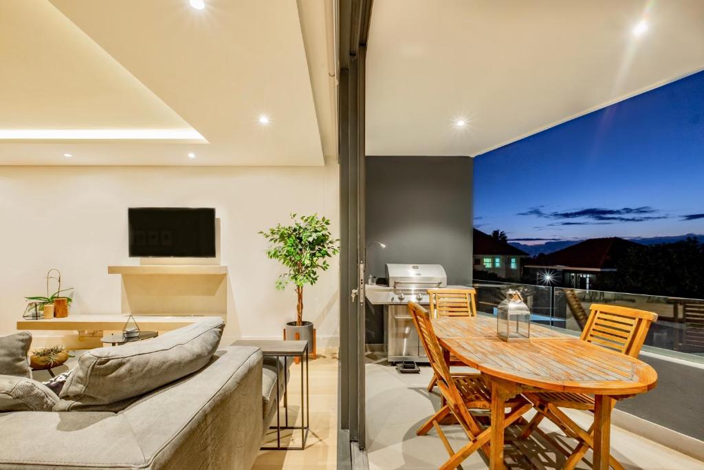 a living room with a couch and a table at The Solis in Cape Town