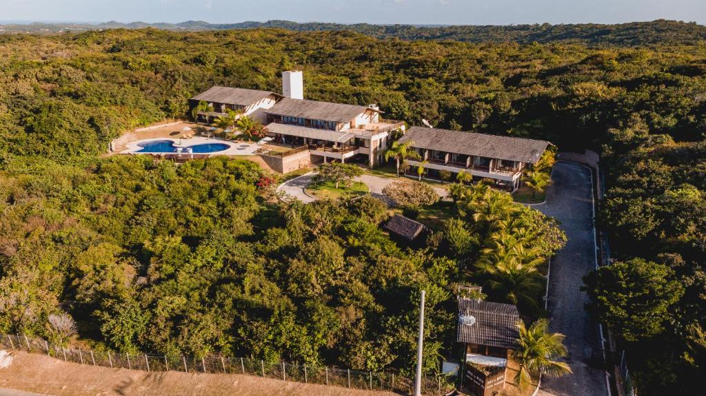 an aerial view of a house with a pool and trees at Oka Da Mata in Pipa