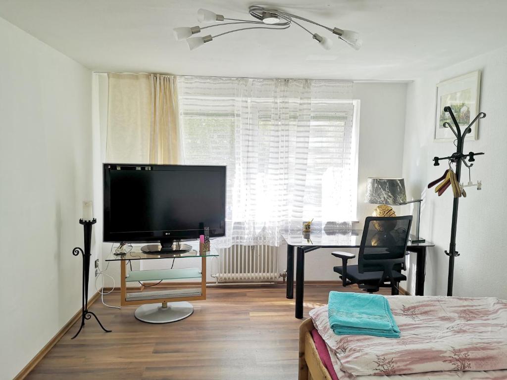 a living room with a large flat screen tv at apartment near underground station in Munich