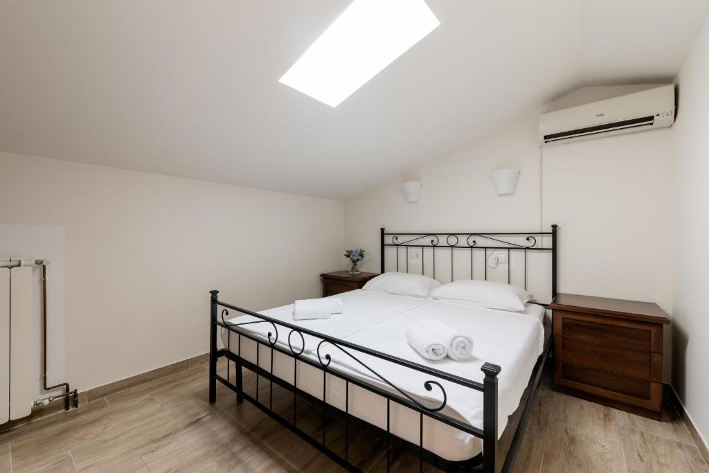 a bedroom with a bed with white sheets and white pillows at Miracolo di Mare Retro in Piran