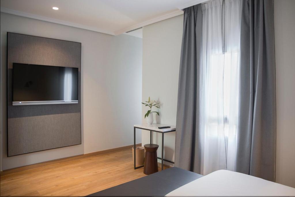 Cama o camas de una habitación en Petit Palace Triball
