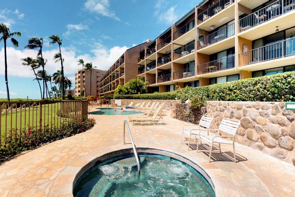 a swimming pool in front of a building at Maalaea Banyans 113 in Maalaea