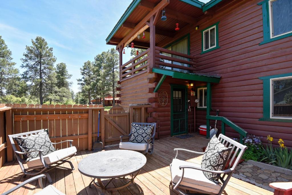 a deck with a table and chairs on a house at 1 Little Rabbit in Pagosa Springs