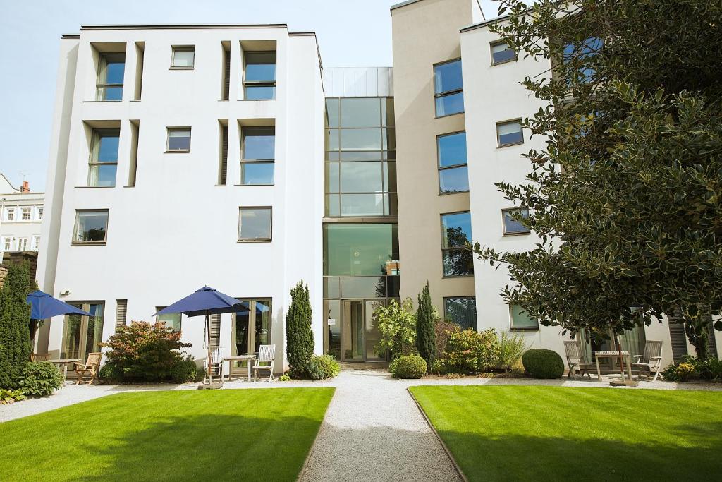 a building with a lawn in front of it at Hart's Hotel in Nottingham