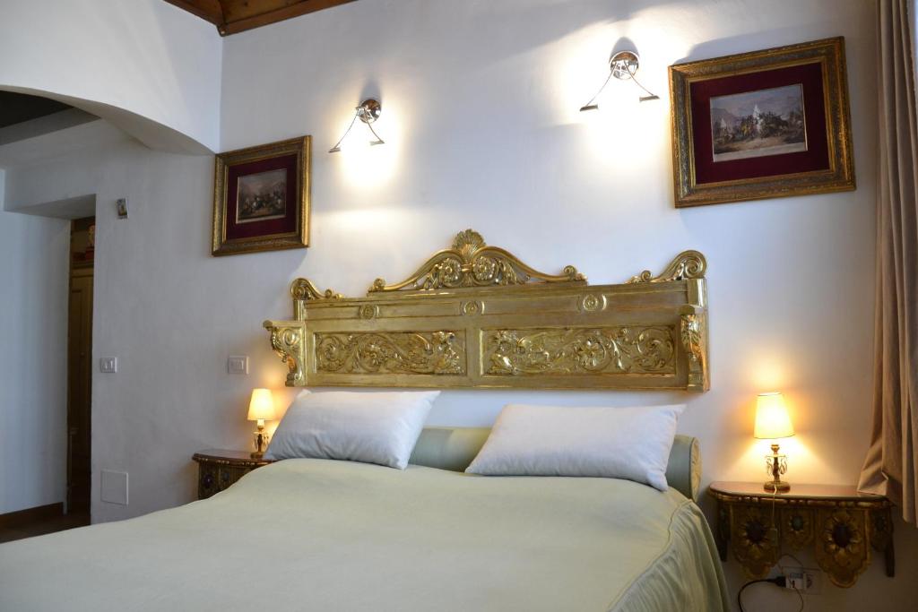 a bedroom with a large bed with two pillows at Alla Locanda Del Cinquecento in Castrocaro Terme