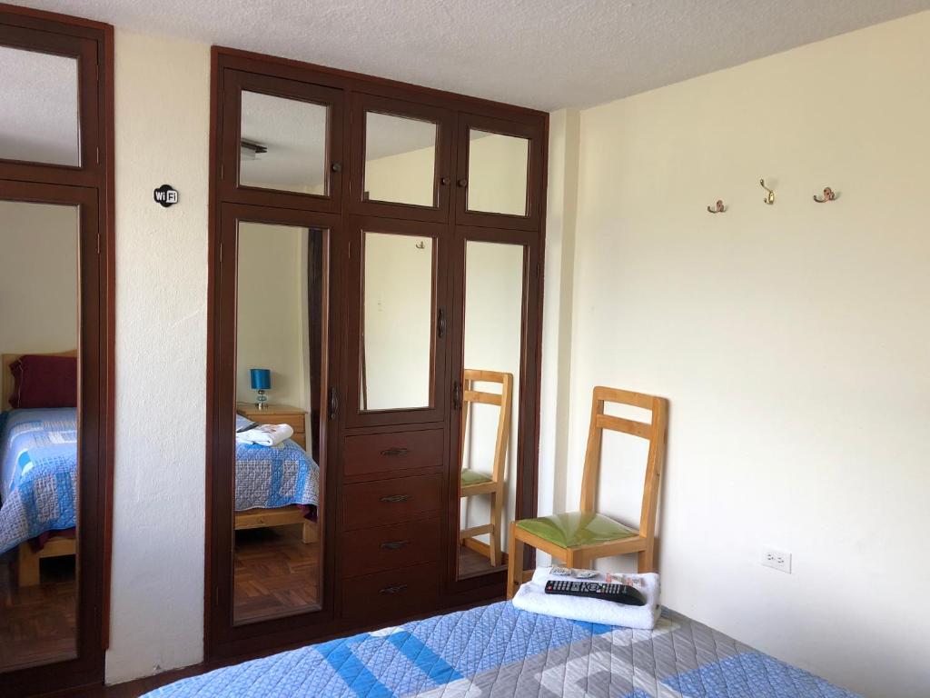 Postel nebo postele na pokoji v ubytování Hostal Monte Carmelo