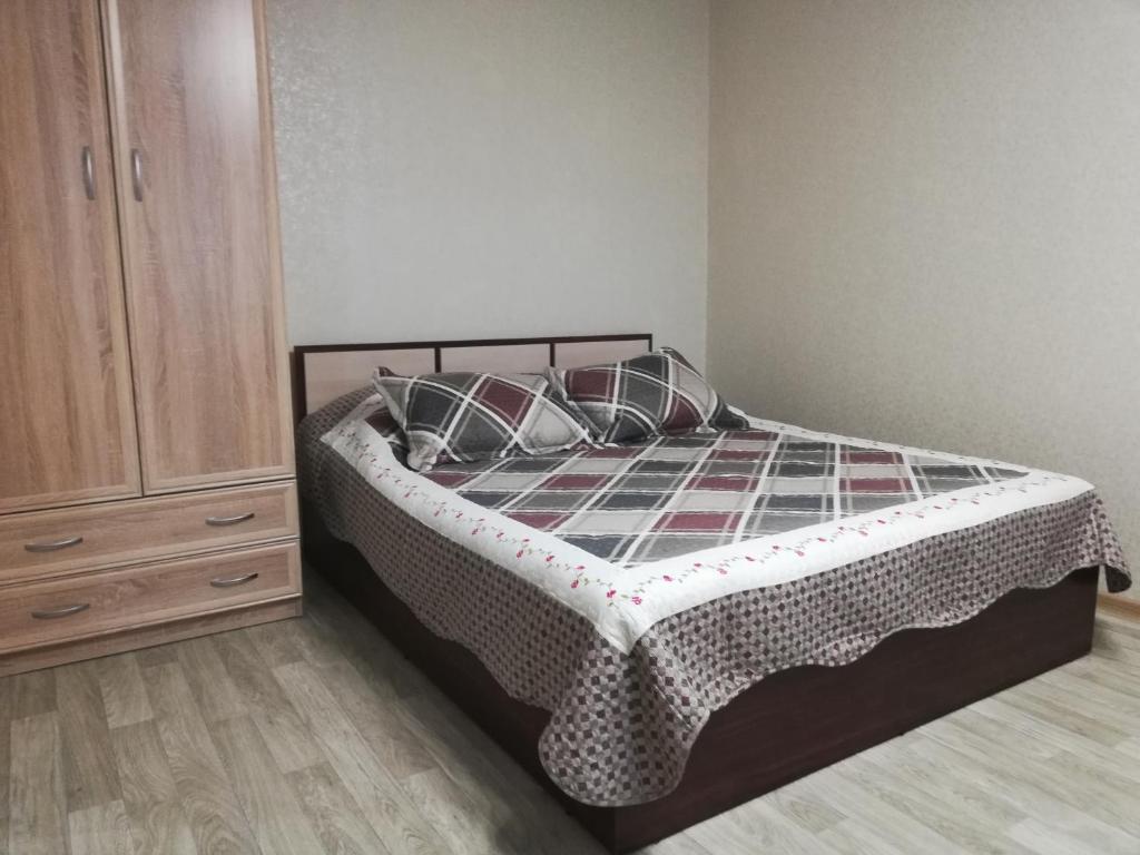ノヴォシビルスクにあるApartment Finika5 m. Rechnoj Vokzalのベッドルーム1室(枕付きのベッド1台、ドレッサー付)