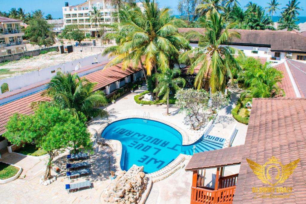 an overhead view of a resort with a swimming pool and palm trees at Jangwani Sea Breeze Resort in Dar es Salaam