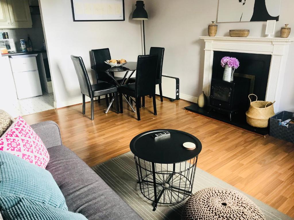 a living room with a couch and a table with chairs at City Centre Georgian Apartment in Dublin