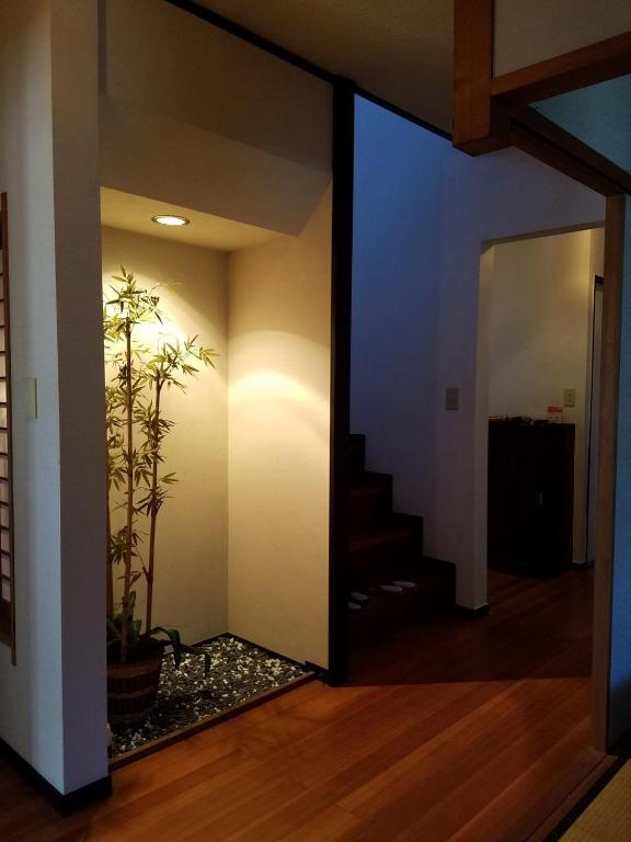 a hallway with a staircase and a potted plant at Bibi Vacation Rental Only 2 groups per day Vacation STAY 1284 in Sakai
