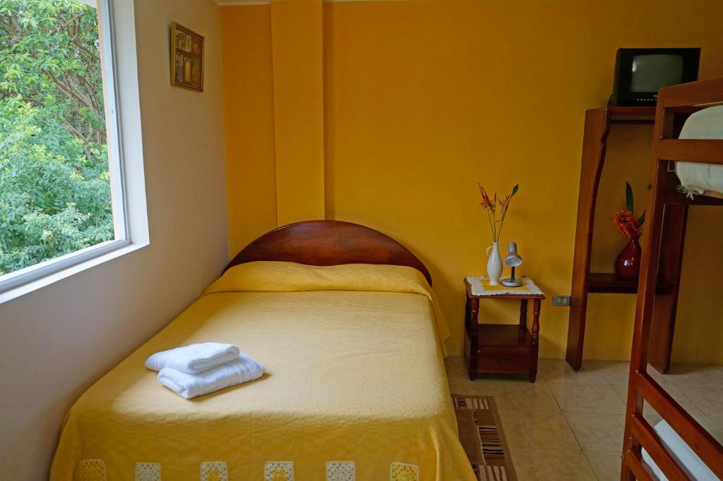 Postel nebo postele na pokoji v ubytování Mindo Real