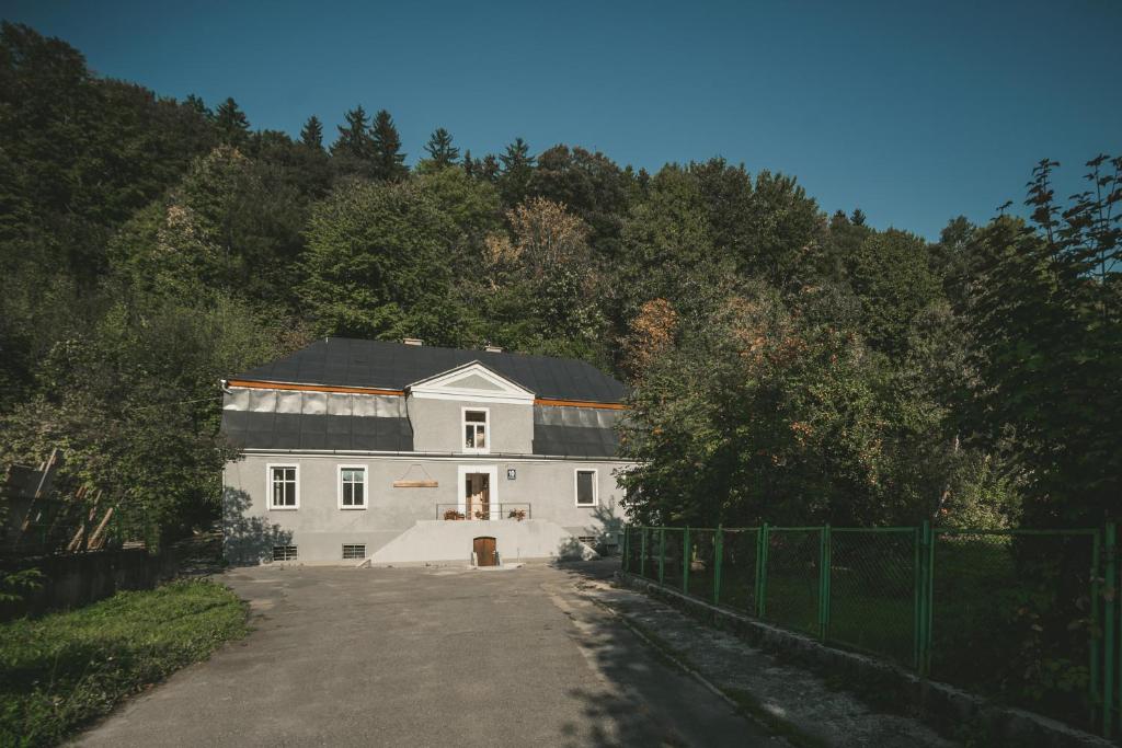 a large white house in the middle of a road at Apartamenty W Starym Ogrodzie in Duszniki Zdrój