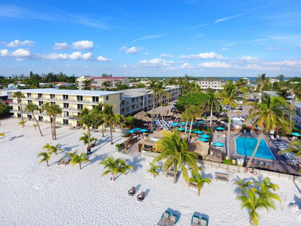 an aerial view of a resort with a pool and palm trees at Outrigger Beach Resort in Fort Myers Beach