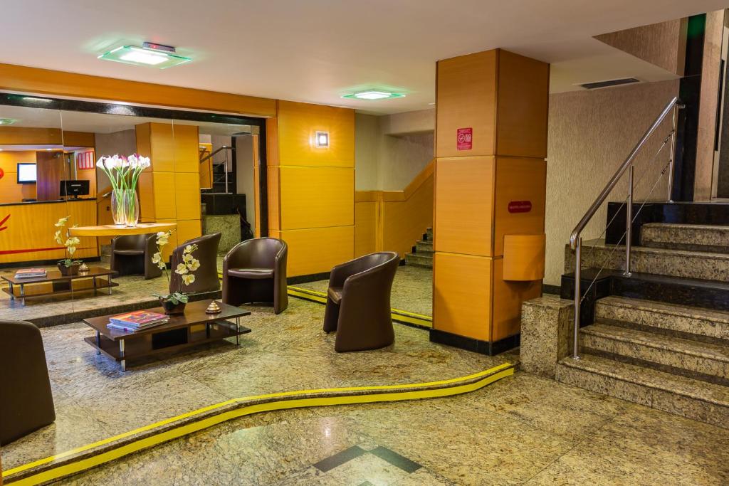 a lobby with chairs and a table and stairs at Hotel Vermont Ipanema in Rio de Janeiro