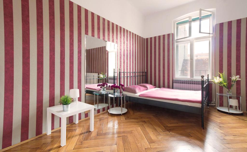 a bedroom with red and white striped walls and a bed at Guesthouse Centar 2 in Zagreb