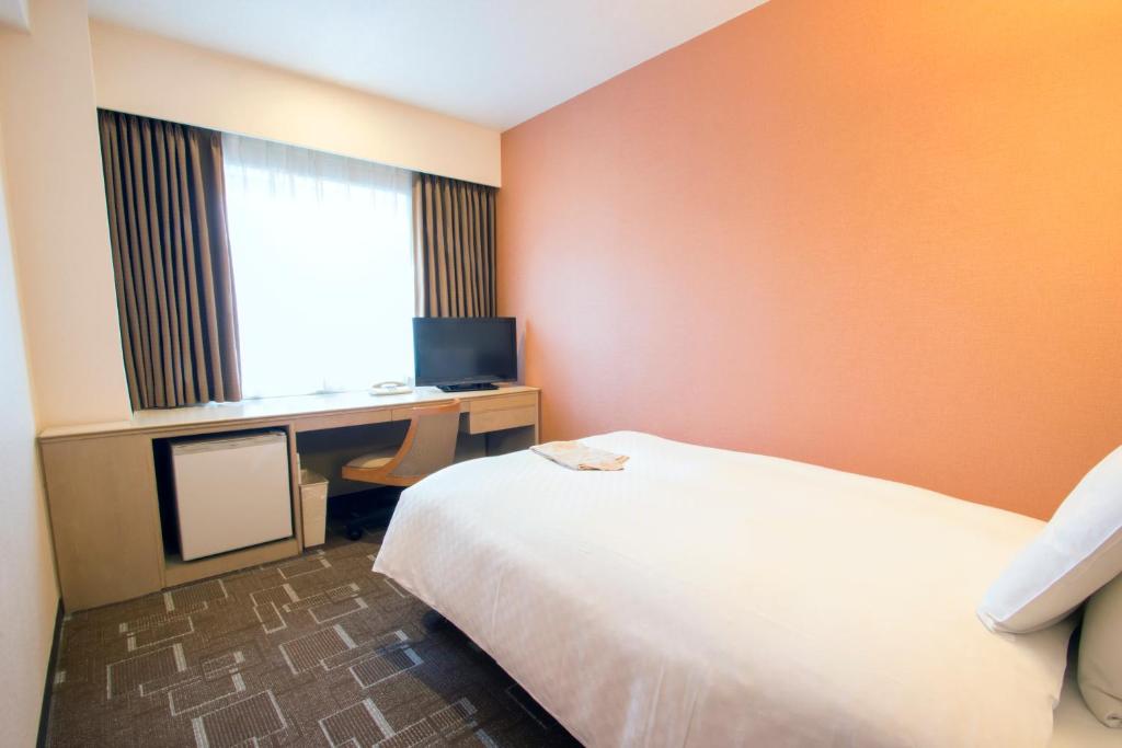 Postel nebo postele na pokoji v ubytování IP City Hotel Osaka - Imperial Palace Group