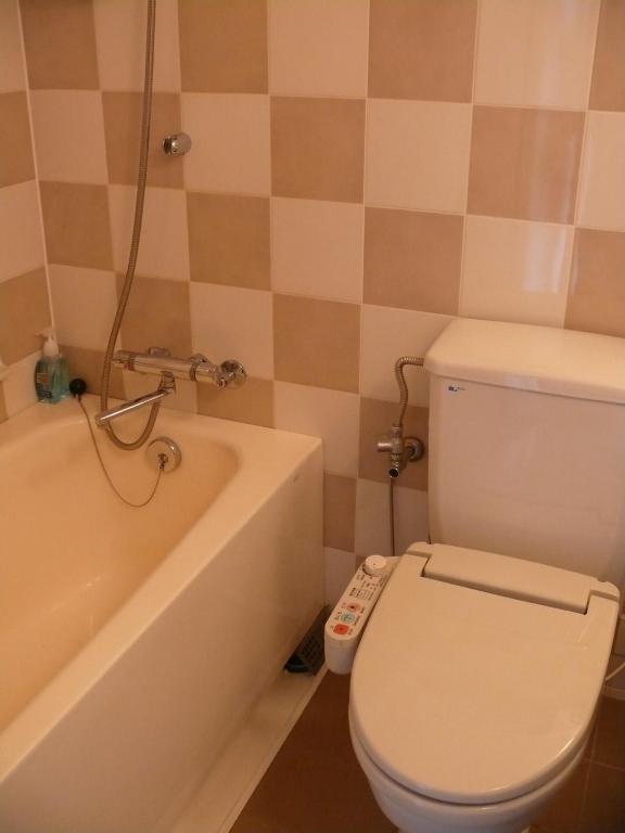 a bathroom with a toilet and a bath tub at Shibuya Excel Hotel Tokyu in Tokyo