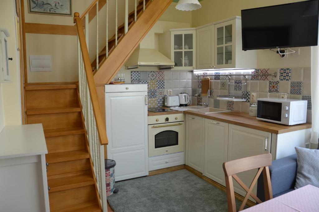 a small kitchen with a staircase leading up to a stair case at Our House In The Town in Veliko Tŭrnovo