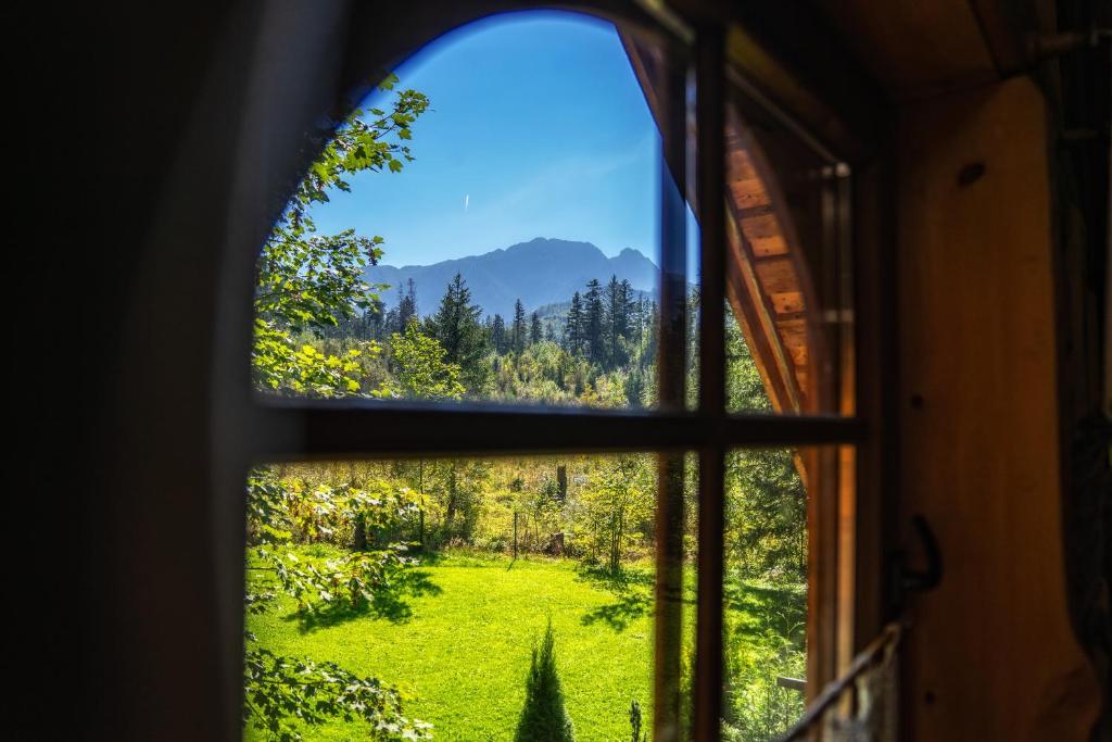 a view from a window of a field and mountains at Mountain Shelter by Loft Affair in Zakopane