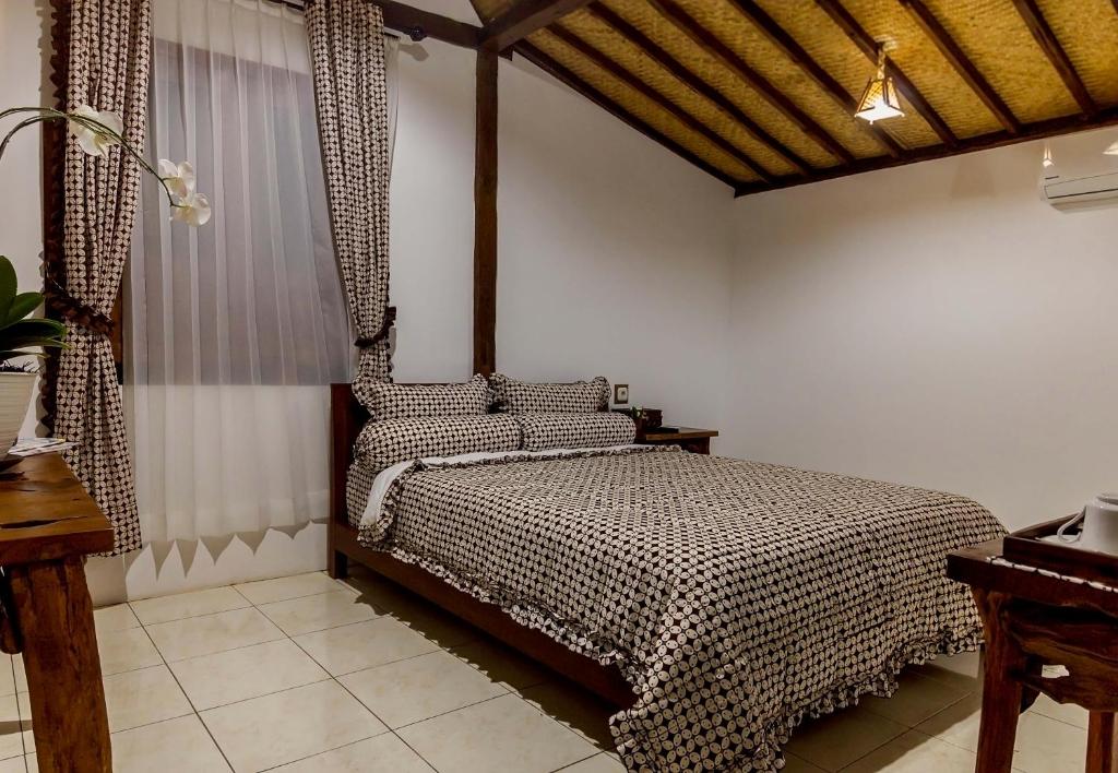 Letto o letti in una camera di The Omah Borobudur
