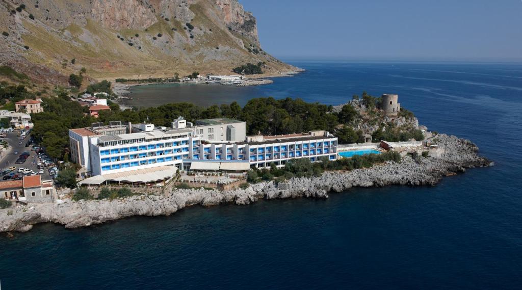 a large building on an island in the water at Splendid Hotel La Torre in Mondello