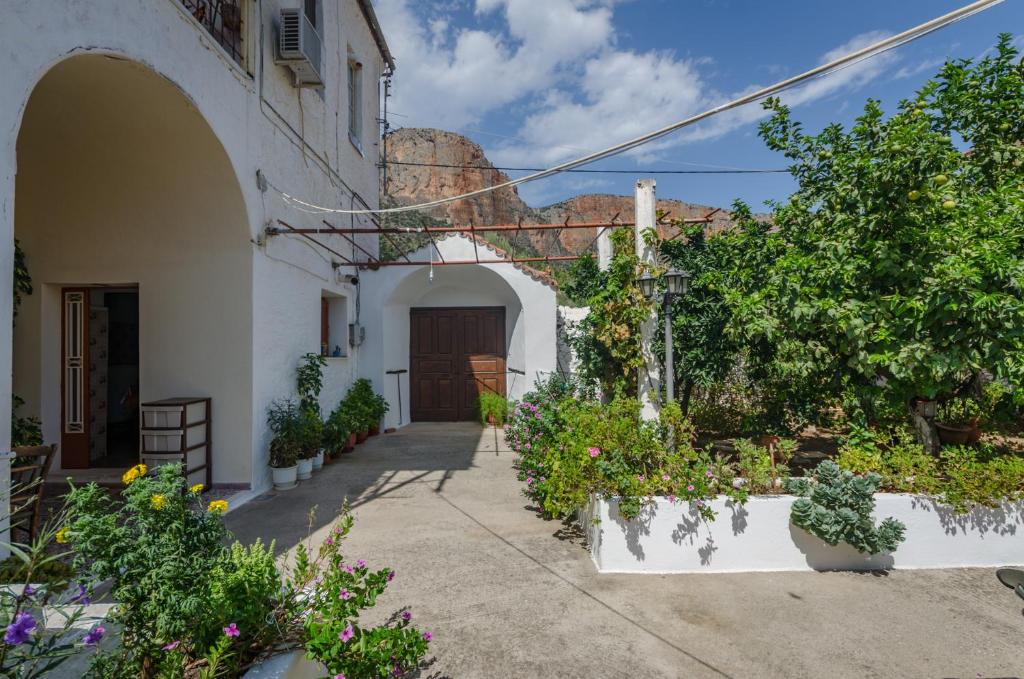 a courtyard of a building with flowers and plants at Irini and Petros House in Leonidio