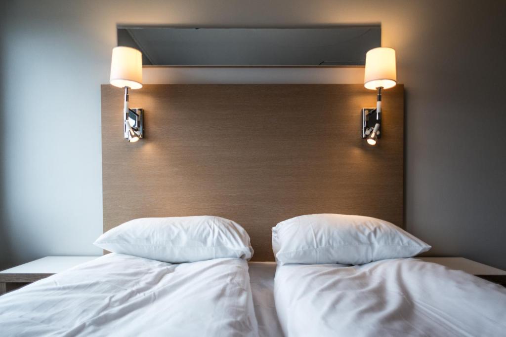 Postel nebo postele na pokoji v ubytování City Living Sentrum Hotel