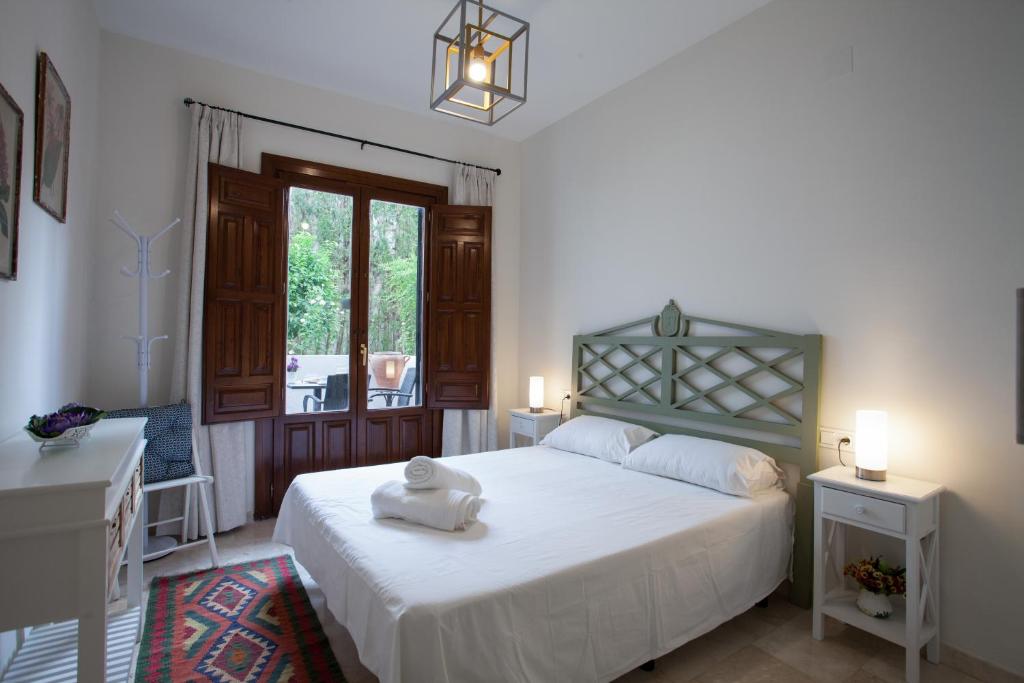 グラナダにあるApartamento De Lujo En Antiguo Conventoのベッドルーム(大きな白いベッド1台、窓付)