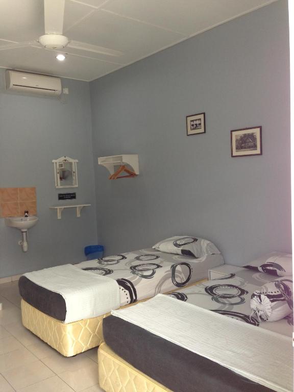 Postel nebo postele na pokoji v ubytování Nipah Guesthouse Pangkor