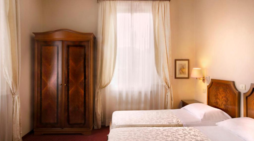 Postel nebo postele na pokoji v ubytování Hotel Settentrionale Esplanade