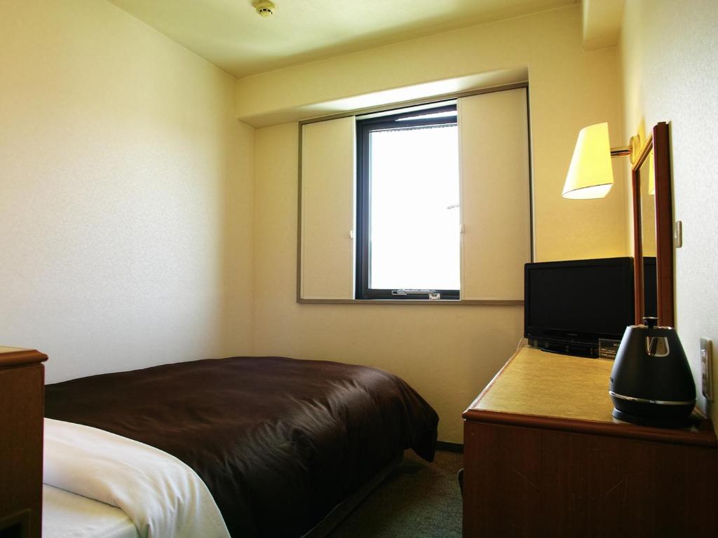 Postel nebo postele na pokoji v ubytování Tourist Hotel Hitachi