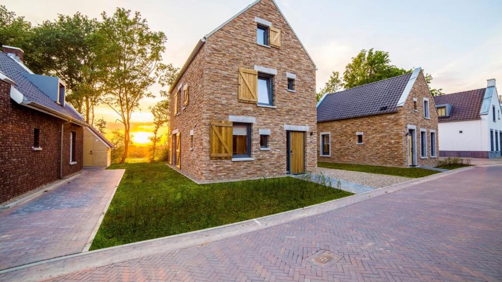 a brick house with a courtyard in the middle at Dormio Resort Maastricht in Maastricht