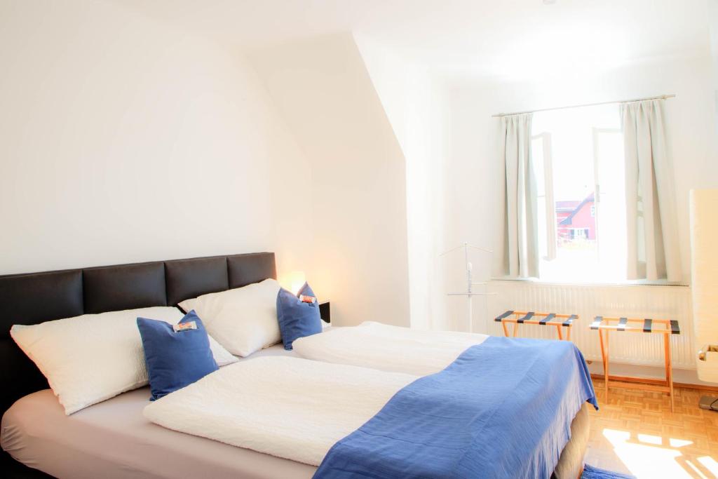 a bedroom with a bed with blue and white pillows at Villa Leopoldskron in Salzburg
