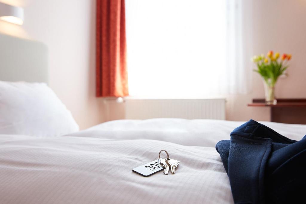 Postel nebo postele na pokoji v ubytování Hotel Anhalt