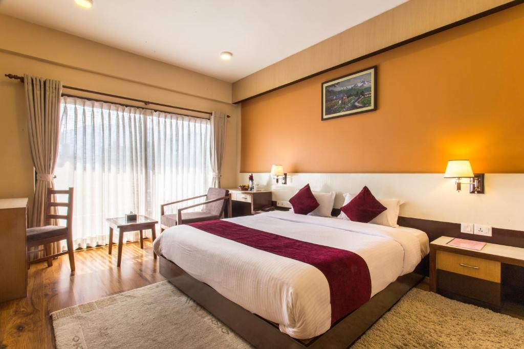 Rúm í herbergi á Hotel Queens Park