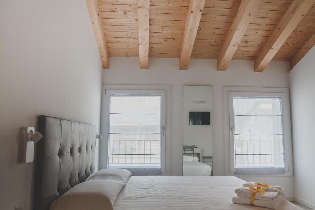 A bed or beds in a room at Terra Ferma Rooms&More