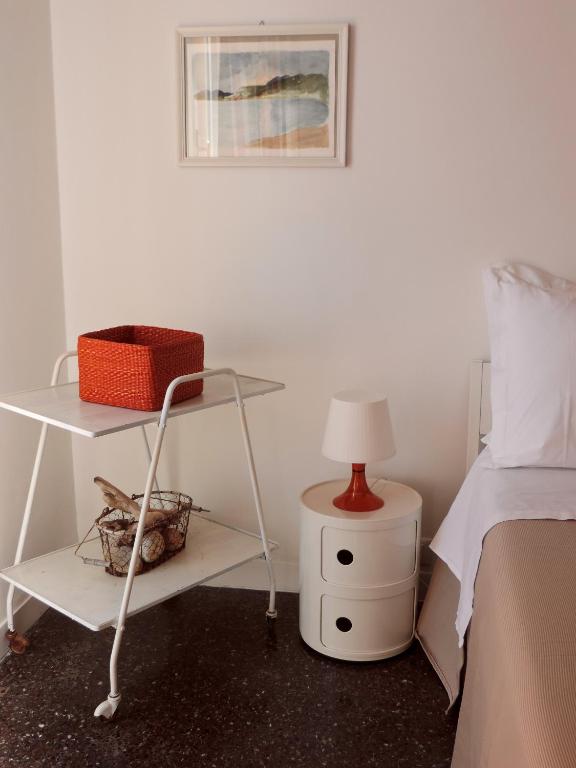 a bedroom with a bed and a table with a lamp at Le Casasse "Paradiso" in Varigotti