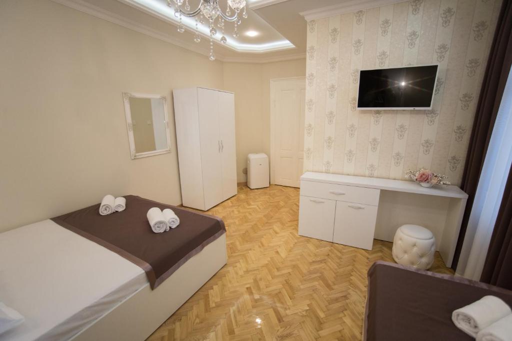Postel nebo postele na pokoji v ubytování Center Deluxe Garni Hotel