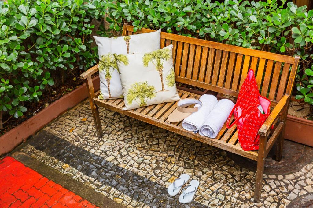 a wooden bench with pillows and towels on it at Hotel Vermont Ipanema in Rio de Janeiro