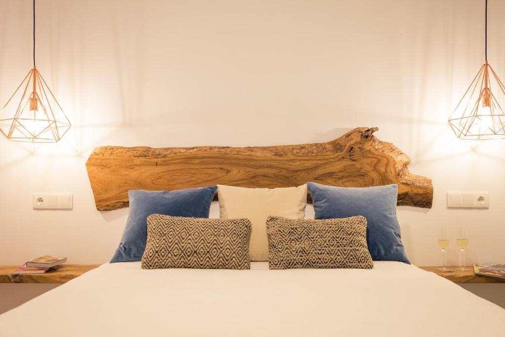 a bedroom with a bed with blue and white pillows at Fortuna in Los Caños de Meca