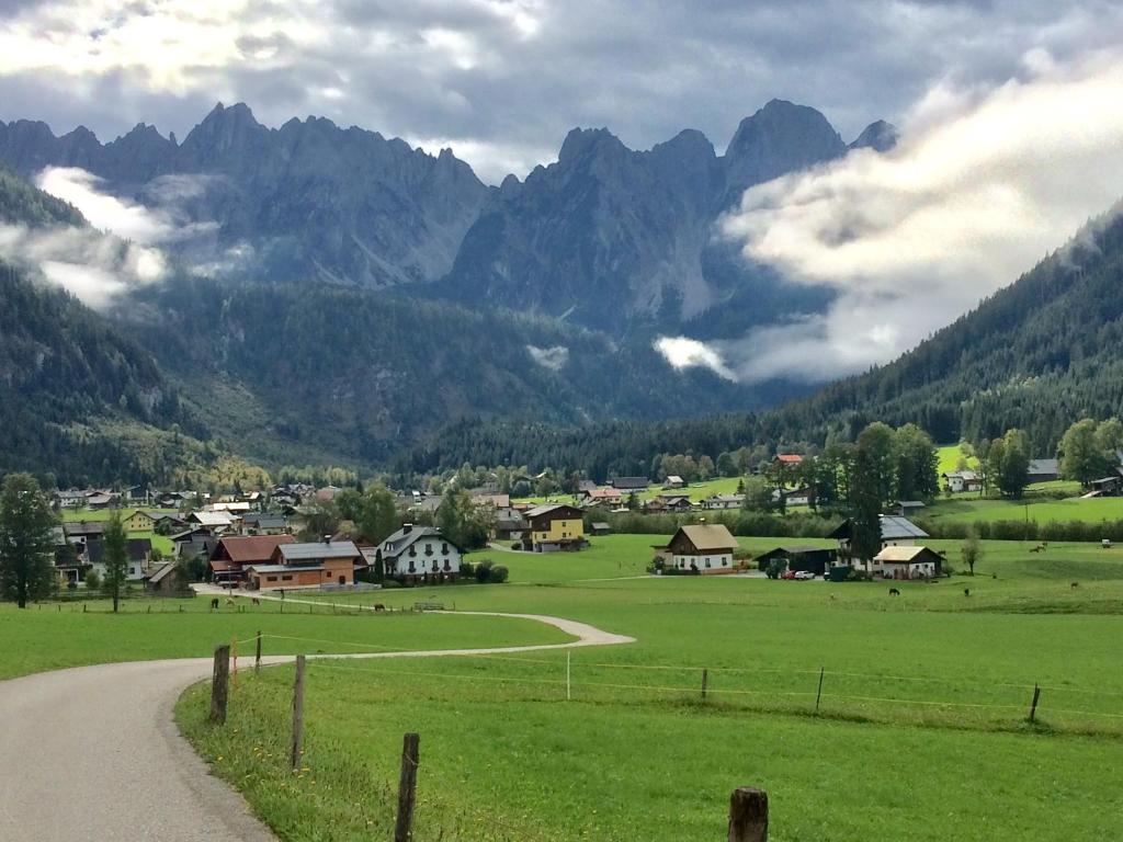 a village in a valley with mountains in the background at Dachstein Mountainview Gosau in Gosau