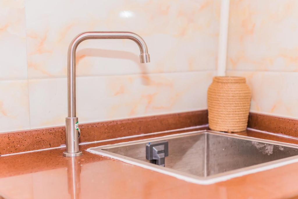 a sink in a kitchen with a faucet at Qingdao Shinan·Qingdao Landing Stage· Locals Apartment 00133930 in Qingdao