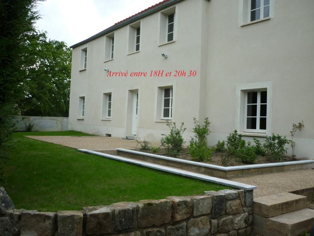 a white building with a sign on the side of it at Heartwood in Arbonne-la-Foret